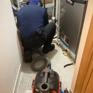technician using shop-VAC machine on home or business property during drain cleaning